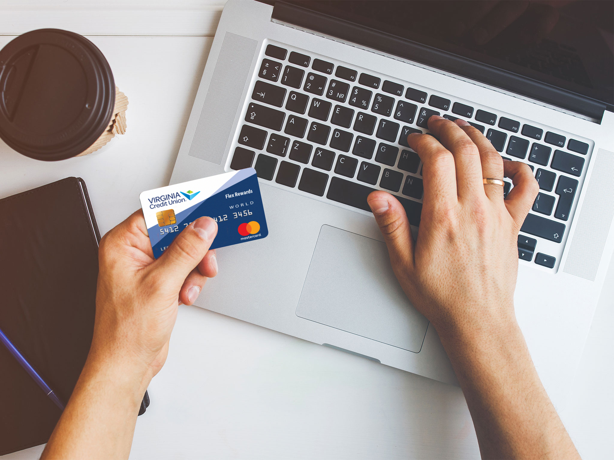 A user entering credit card information on a laptop