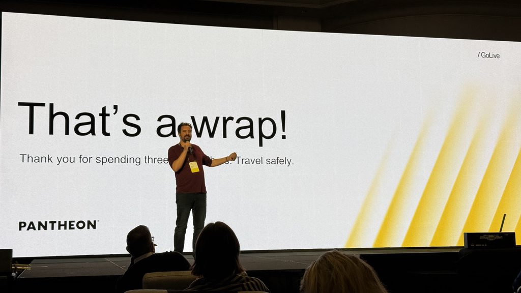 Presenter on stage in front of a slide reading “That’s a wrap!” with “PANTHEON” and “/ GoLive” visible.